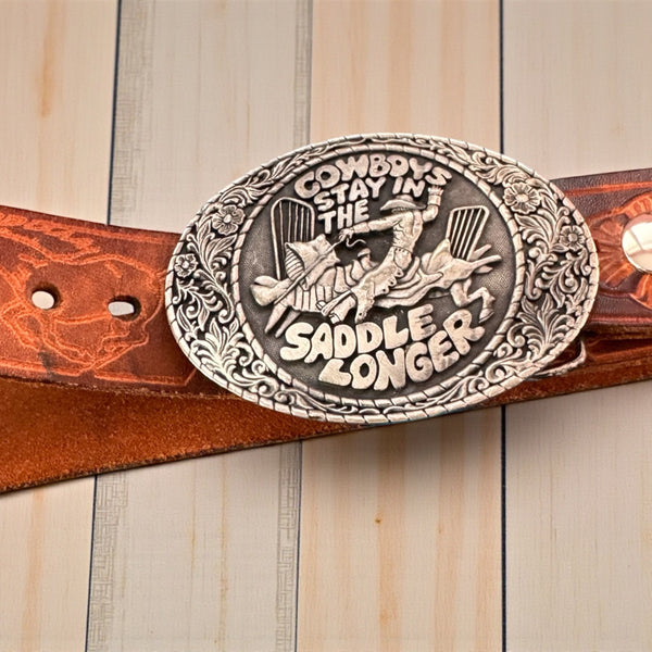 1981 VINTAGE BROWN LEATHER BELT WITH SILVER COWBOY BUCKLE