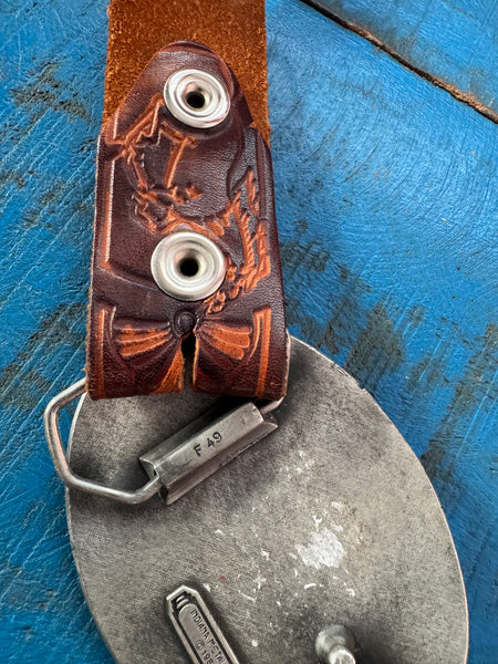 1981 VINTAGE BROWN LEATHER BELT WITH SILVER COWBOY BUCKLE