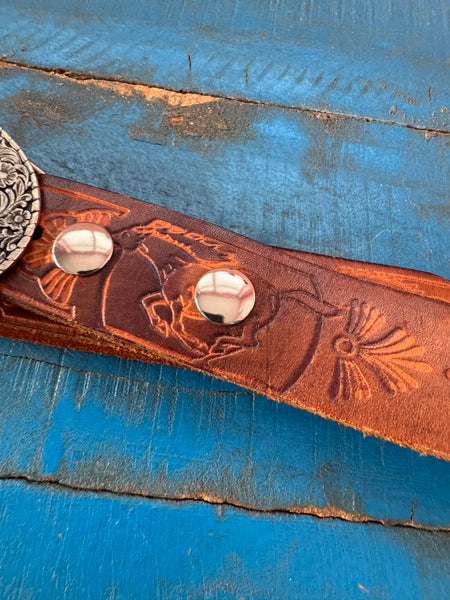 1981 VINTAGE BROWN LEATHER BELT WITH SILVER COWBOY BUCKLE